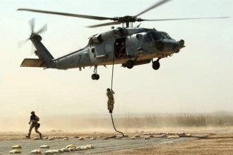 Operators fast roping from the 160th SOAR (A) helicopter
