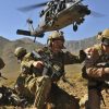 US Air Force Pararescue Jumpers (PJs) deployed, helicopter taking off in the background