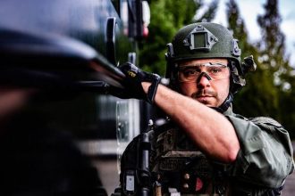 Washington County Tactical Negotiations Team (TNT) operator preparing to move to the target building