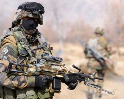 Legionnaire of French Foreign Legion brandishing his FN Minimi machine gun