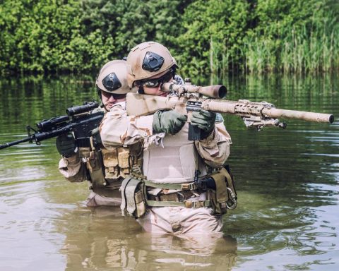 Two U.S. Navy Seals navigating through swamp during the training
