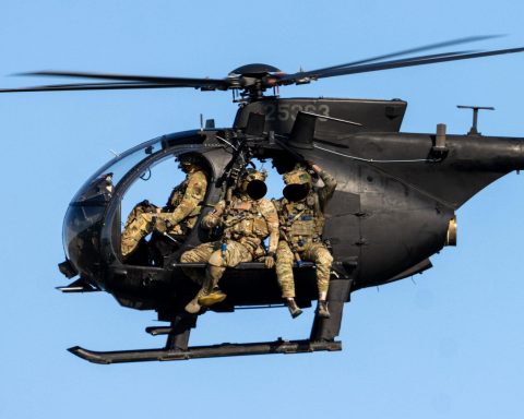 SEAL operators sitting on the planks of the Little Bird