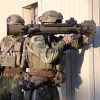 Two soldiers aiming a Carl-Gustaf M4 recoilless rifle from behind cover