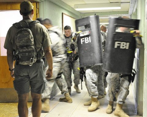 FBI agents training with ballistic shields in a building
