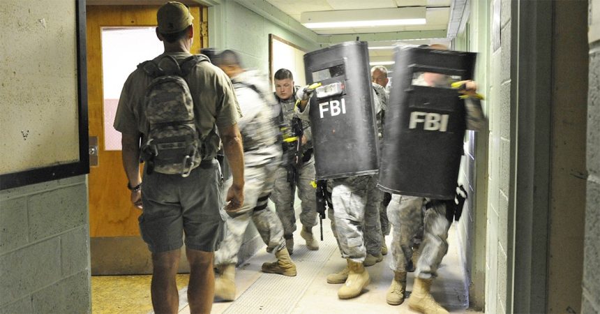FBI agents training with ballistic shields in a building