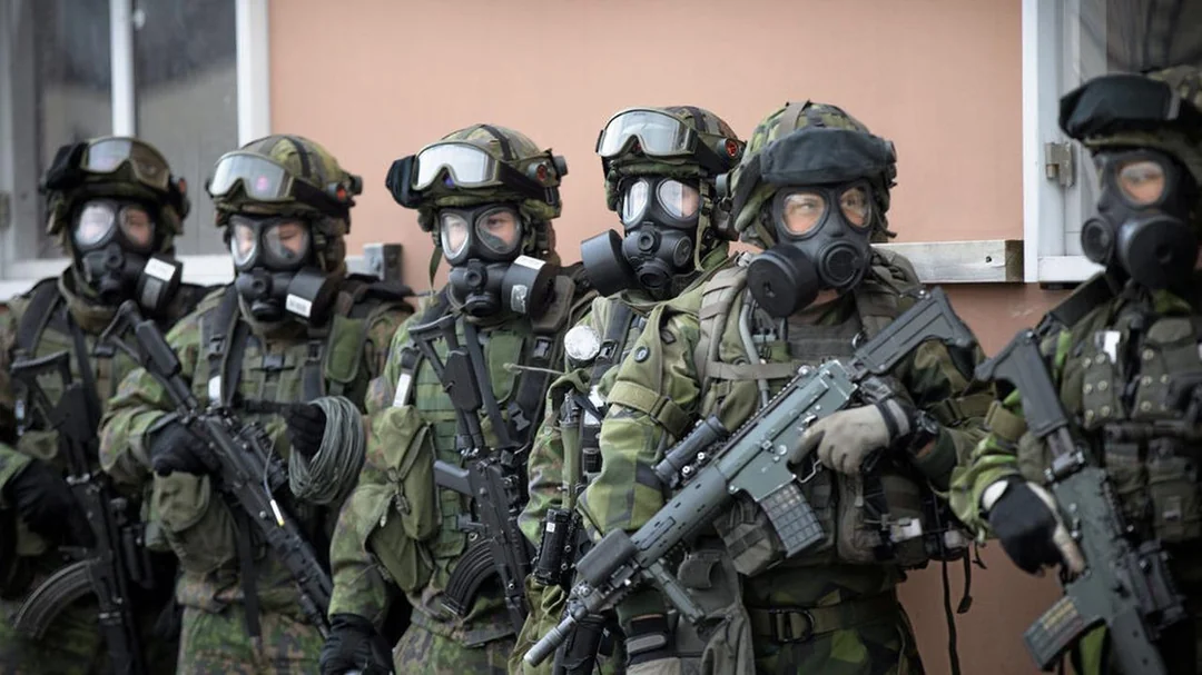 Finnish and Swedish soldiers wearing gas masks during urban combat training, highlighting gas mask seal challenges with beards