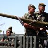 Three French Foreign Legion soldiers posing with a 9K38 Igla (SA-18 Grouse) MANPADS launcher during field operations
