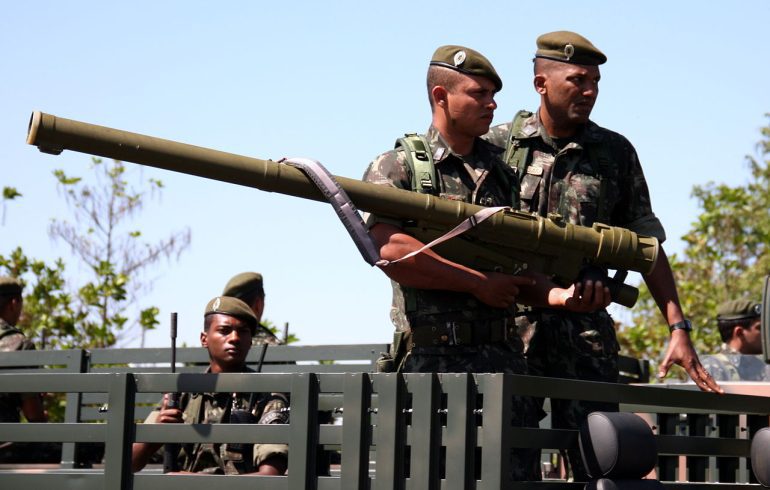 Three French Foreign Legion soldiers posing with a 9K38 Igla (SA-18 Grouse) MANPADS launcher during field operations