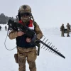 Turkish soldier carrying IHASAVAR anti-drone jamming backpack system during a security operation.