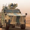 Turkish Kirpi II MRAP armored vehicle driving across desert terrain during military exercises.
