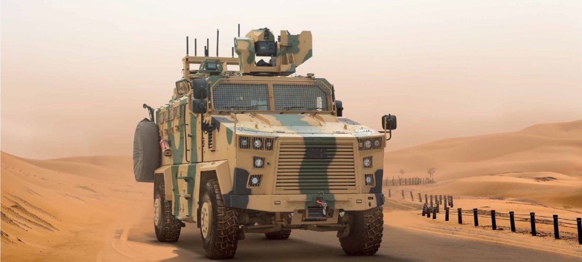 Turkish Kirpi II MRAP armored vehicle driving across desert terrain during military exercises.