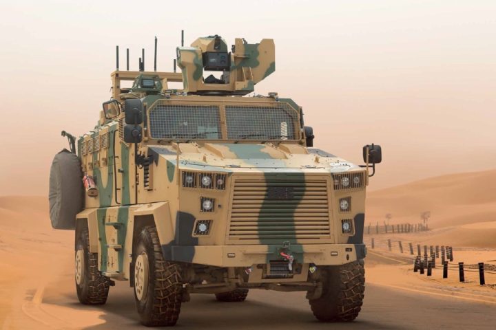Turkish Kirpi II MRAP armored vehicle driving across desert terrain during military exercises.