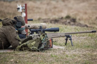 A Ukrainian soldier aiming with McMillan TAC-50 sniper rifle