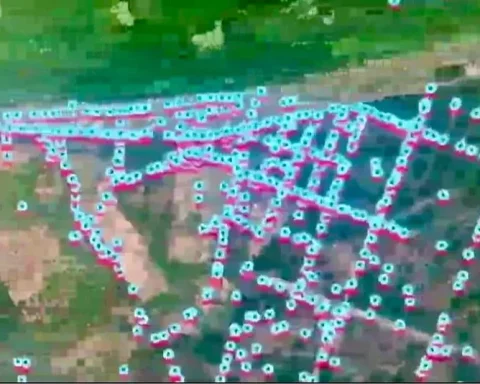 A military drone flying over a marked minefield during the Ukraine-Russia conflict.