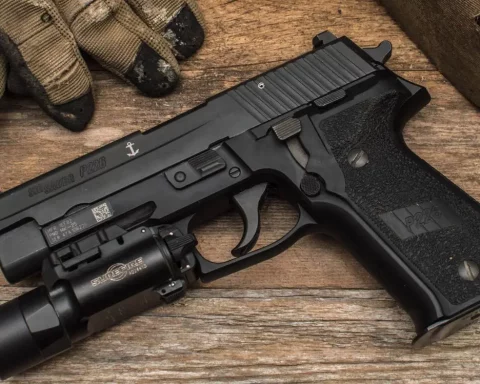 SIG Sauer P228 with flashlight attached on Picatinny rail