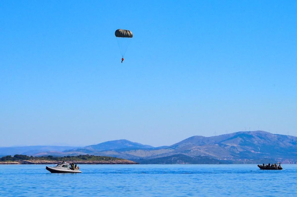 Special Forces parachuter lands in water during joint exercise