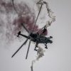 CAIC Z-10 attack helicopter in flight deploying defensive flares during evasive maneuvers.