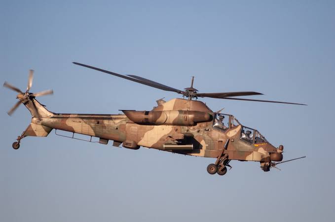 South African Rooivalk attack helicopter flying over open terrain
