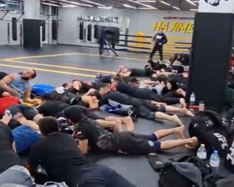 Russian police detain dozens of men lying face down in a gym during a military draft raid in Moscow